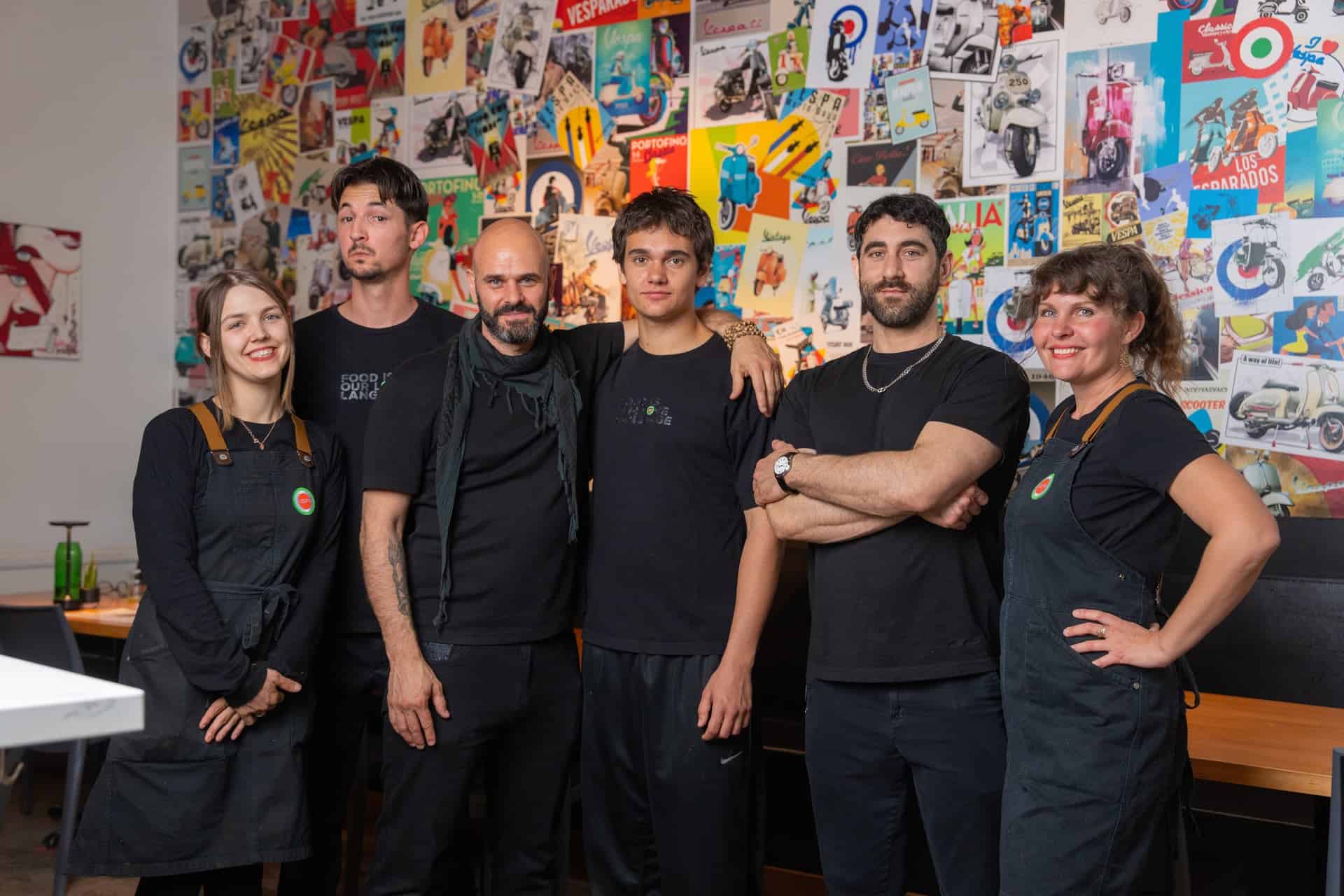 Group of staff members at Vespa Italian Café, a vibrant restaurant and pizzeria.