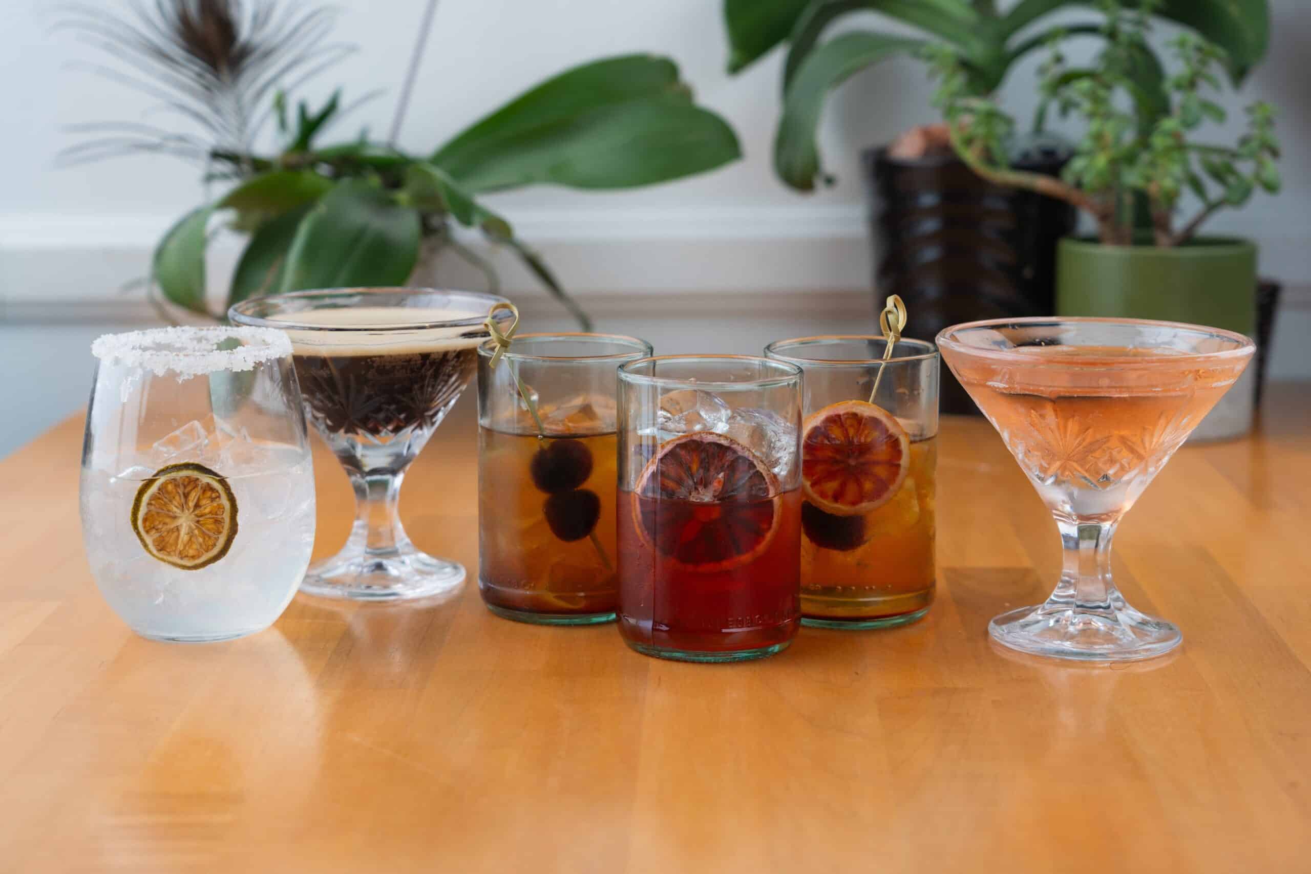 Colorful cocktails with fruits on wooden table at Vespa Italian Café.