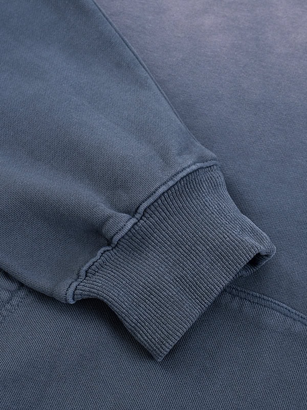 Casual navy blue sweatshirt with ribbed cuff, close-up detail.