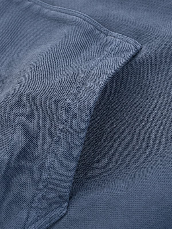 Close-up of navy blue fabric pocket on casual shirt or jacket.